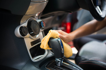 Hand with microfiber cloth cleaningcar