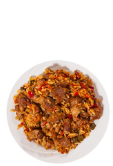 Rice with meat and vegetables on plate. top view. isolated on white