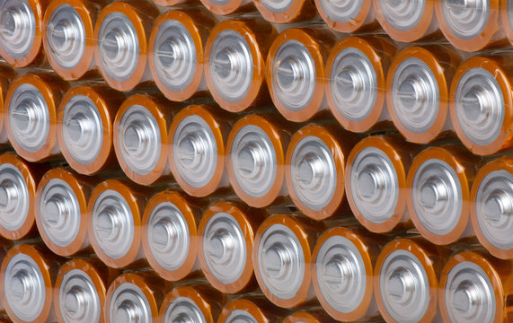 background from rows of orange batteries