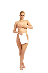 Young naked woman holding blank banner