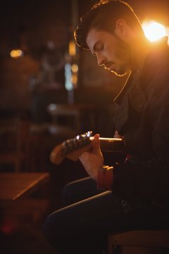 Young man playing guitar 