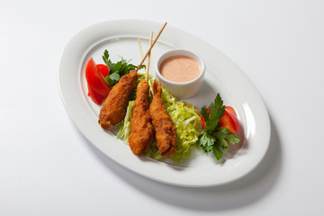 Fried shrimp with salad on white dish