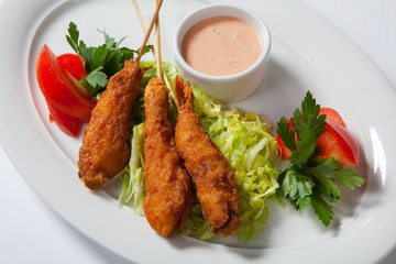Fried shrimp with salad on white dish