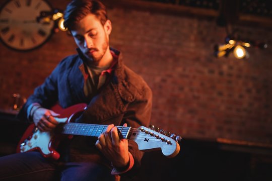 Young man playing guitar 