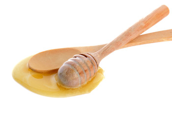 Honey on wooden dipper and wooden spoon isolated on white background