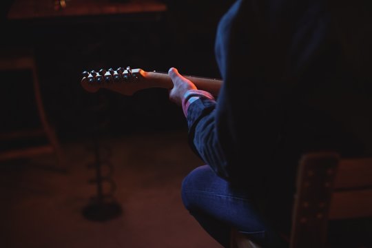 Mid-section of man playing guitar 