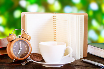 coffee cup and clock on old wood table