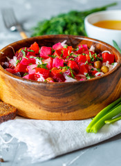 Russian Ukrainian traditional beetroot salad vinaigrette with bread, oil and greens. Love for a healthy vegan food concept