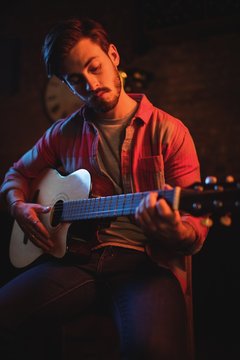 Young man playing guitar 