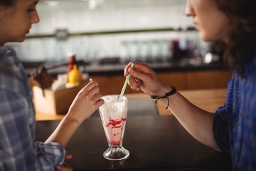 Couple having milkshake at counter