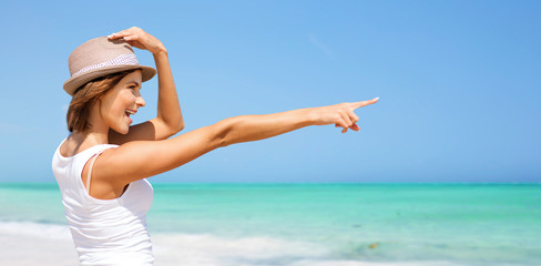 happy young woman in hat on summer beach