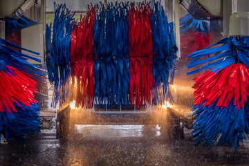 Automated Car Wash in motion with spinning brushes and spraying water