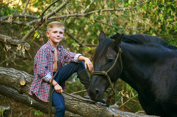 the boy on the ranch next to his horse