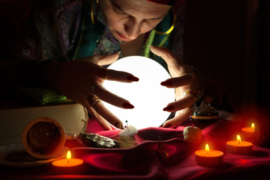 Gypsy fortune teller staring in crystal ball