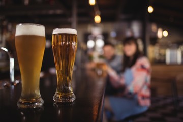 Two beer glasses on worktop