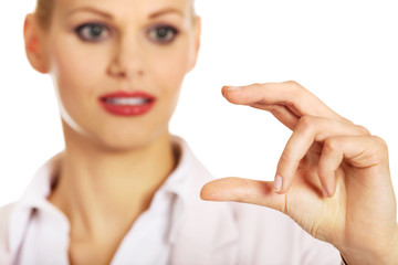 Young businesswoman showing copy space or something between fingers