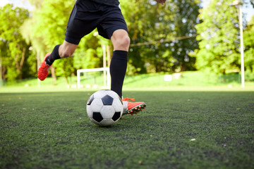 soccer player playing with ball on field