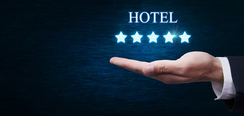 Hand holding five stars and inscription Hotel.