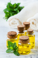 Organic essential oil with green mint leaves, spa concept