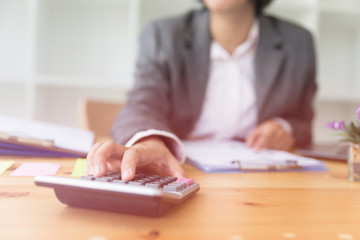 Business person using a calculator to calculate the numbers. Accounting , Accountancy, Calculation Concept.
