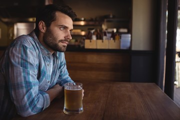 Thoughtful man having beer