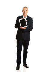 Happy businessman holding digital tablet