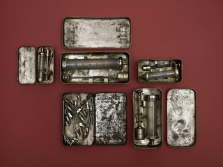 Directly above shot of old-fashioned medical tools on red background