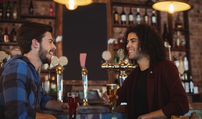 Friends having beer at bar counter