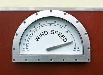 Wind speed monitor attached to wood wall.