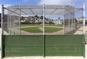 View of community park baseball field from behind backstop.