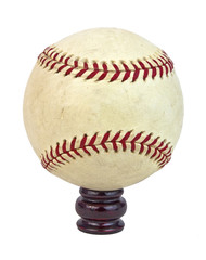 Scuffed baseball on small wooden pedestal. Isolated.