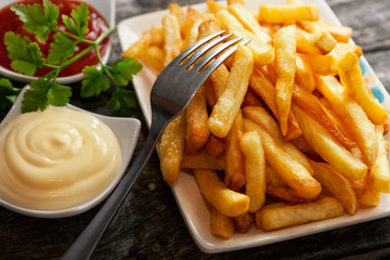 Close up of bowl with french fries and fork