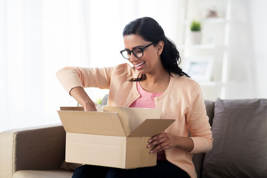 Happy Young Indian Woman With Parcel Box At Home