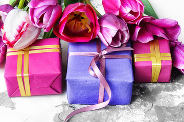 Bouquet of purple tulips and gift box