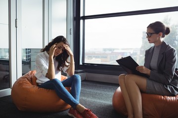 Unhappy woman consulting counselor