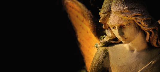 sculpture of an angel with wings against dark background (Religion, faith, Christianity, soul,...