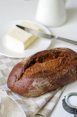 Loaf of rye bread on linen napkin.Selective focus.