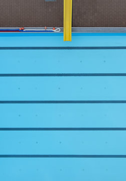 Directly above view of yellow slide by swimming pool