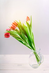 Bouquet of pink tulips on white wooden background. Top view, copy space. Happy mother's day.