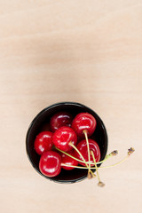 Fresh cherry in a bowl on a table.