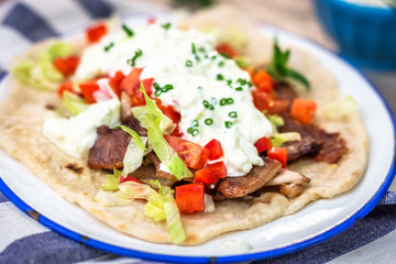 Gyros with vegetable, meat and tzatziki sauce