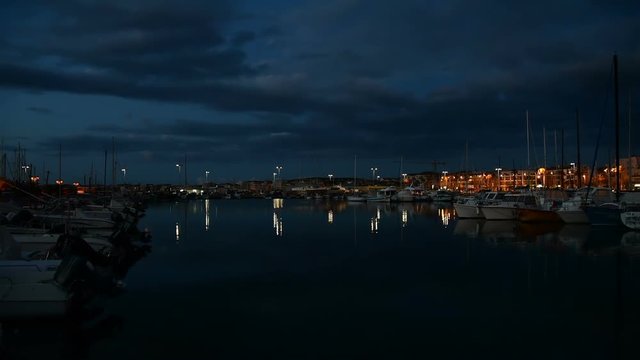Boats in Alghero harbor at night