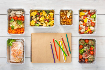 Healthy food take away in boxes, top view at wood