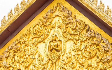 The sculpture carved gable of temple roof with a beautiful golden pattern. The temple is a place of religious importance and public place for general people either Thai people and foreign visitors.