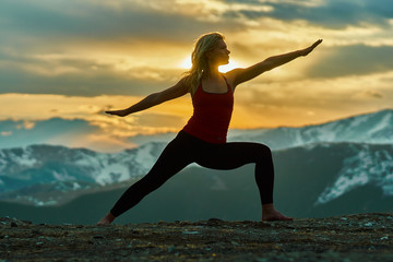 Young woman doing yoga in the mountains