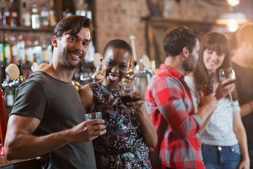 Portrait of happy couple holding drinks