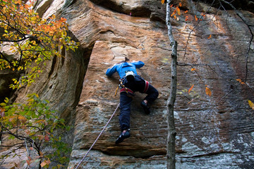 Rock climber ascending a sport route in Red River Gorge, Kentucky, on some wonderful sandstone.