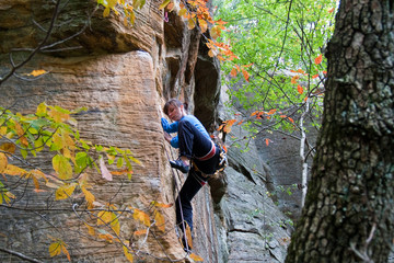 Rock climber ascending a sport route in Red River Gorge, Kentucky, on some wonderful sandstone.