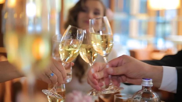 Hands holding glasses and toasting, People cheers with a glass of champagne. happy festive moment, luxury celebration concept. Clinking glasses of champagne in hands