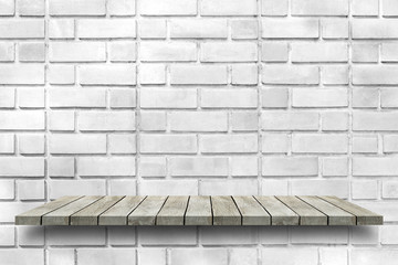 Empty wooden shelf on old white brick wall texture. For display or montage your products with focus wooden shelf top in the foreground